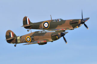 A Hawker Hurricane Mk. XIIa (left) and a Supermarine Spitfire Mk. Ia re-enact the Battle of Britain during a Duxford Airshow. The RAF fighters made good teammates—except during their first wartime encounter.  Antony Nettle/Alamy