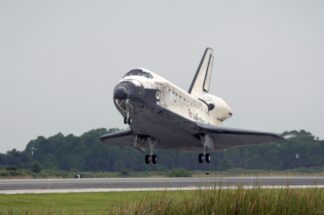 Space_Shuttle_Discovery_s_main_landing_gear_is_about_to_touch_down_on_runway_15_at_Kennedy_Space_Center