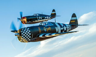 Beautifully restored “razorback” Republic P-47 Thunderbolts owned by The Fighter Collection (foreground) and the Planes of Fame Air Museum fly together.  (© Paul Bowen)